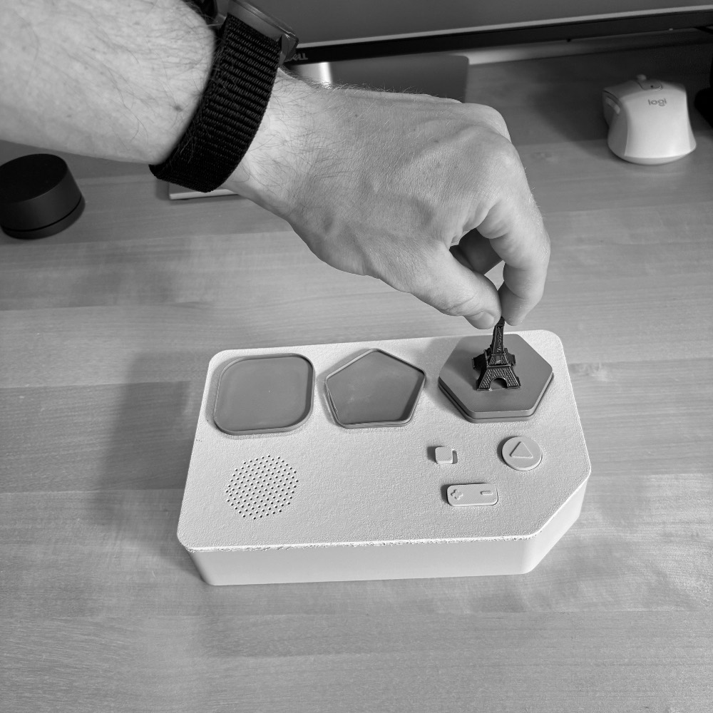 Hands placing a figurine on JoRi
